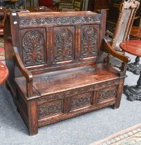 An 18th Century Style Oak Box Settle, initialled and dated 'D.M.S. 1907' to top rail, above three