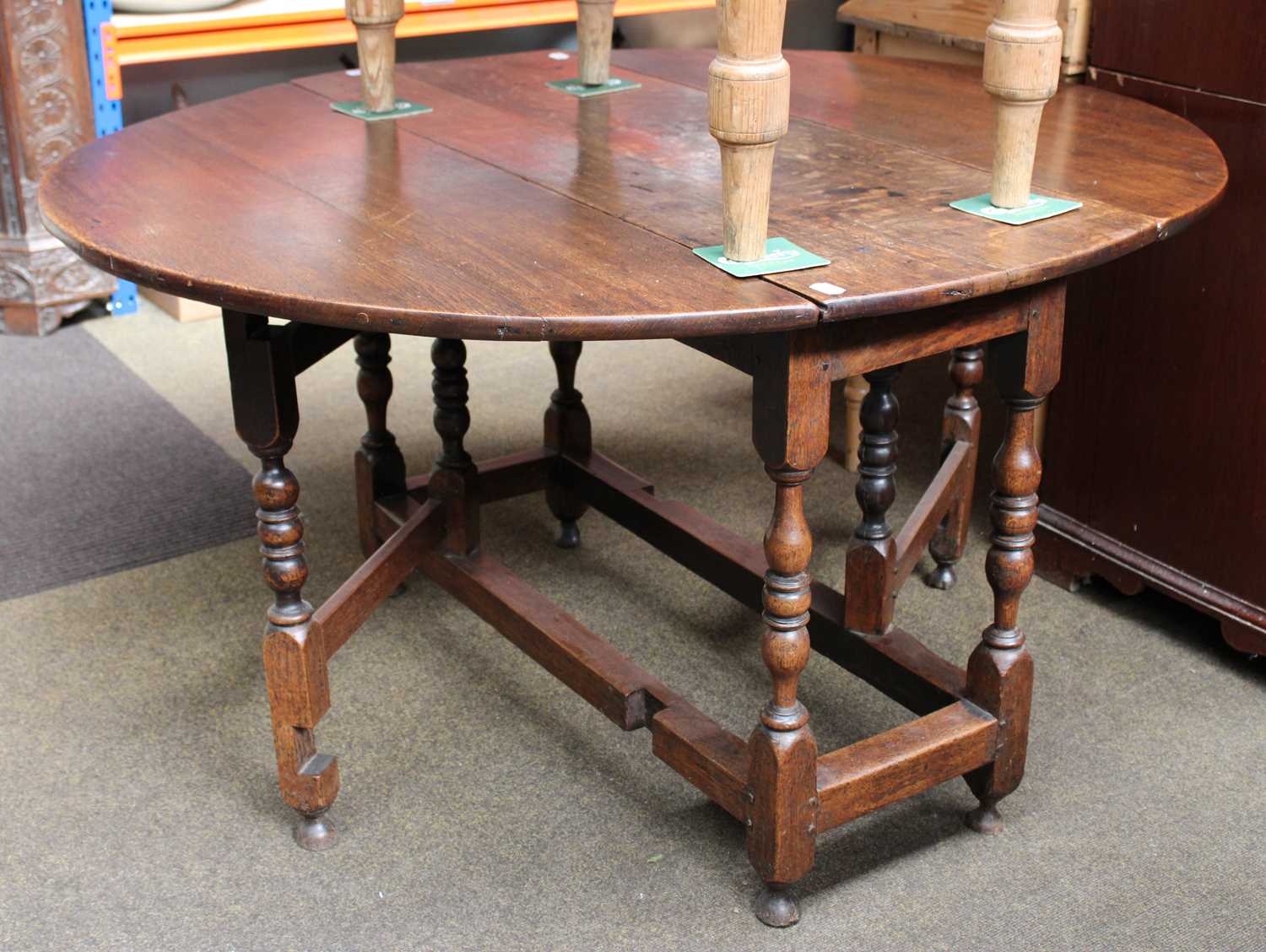 An 18th Century Oak Gateleg Table, the oval top over baluster turned supports, with single drawer,