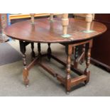 An 18th Century Oak Gateleg Table, the oval top over baluster turned supports, with single drawer,