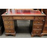 An Edwardian Mahogany Twin Pedestal Desk, with tooled red leather inset over an arrangement of