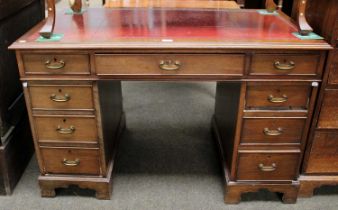 An Edwardian Mahogany Twin Pedestal Desk, with tooled red leather inset over an arrangement of