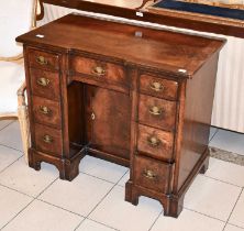 An Early-20th Century Cross and Feather Banded Mahogany Desk, the moulded rectangular top with re-