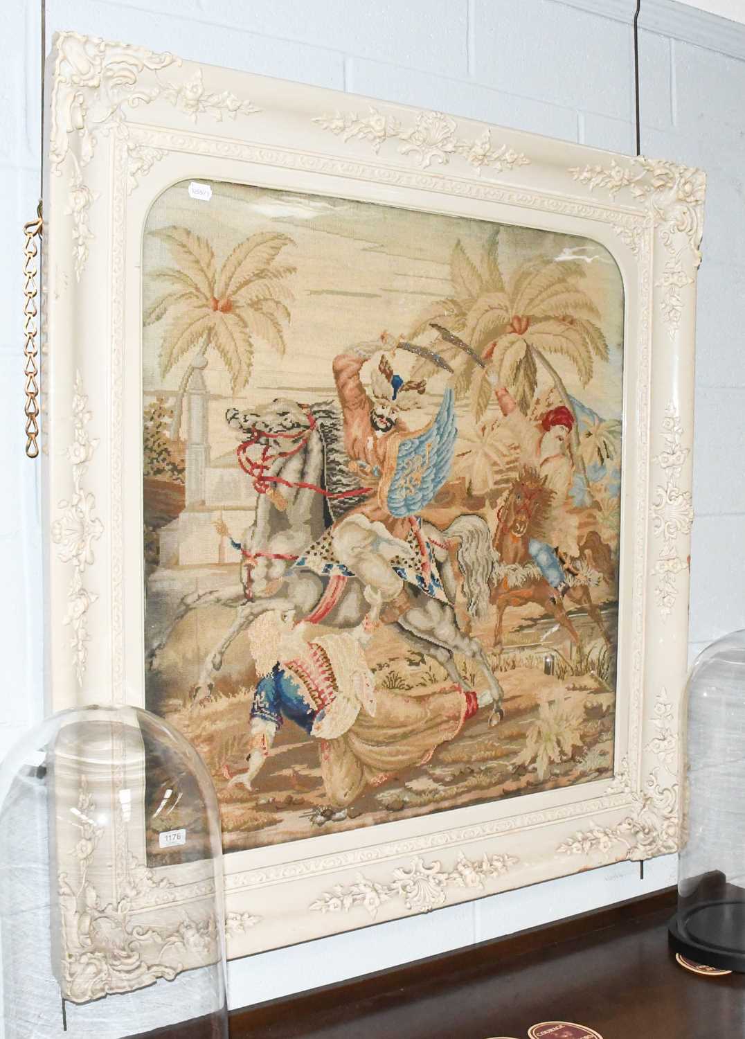 A Victorian Needlework Panel, depicting Indian figures on horseback, 86cm by 81cm not including