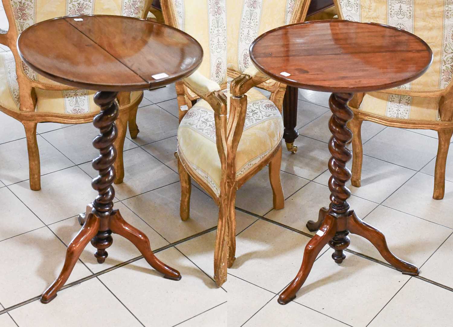 A Pair of Mahogany Tripod Tables, the circualr dished tops supported by a boldly turned standard and