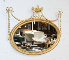 A Regency Style Oval Mirror, with urn and swag surmount, 100cm by 78cm