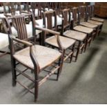 A Set of Seven Early 19th Century Rail Back Chairs, with rush seats, including one carver.