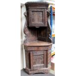 A 17th Century Style Heavily Carved Oak Full-Height Corner Cupboard, some early timbers, the upper