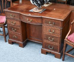 An Edwardian Cross-banded Mahogany Inlaid Desk, the bow front above a recess fitted with a