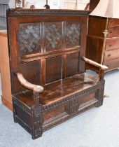 An 18th Century Carved Oak High Backed Box Settle, 136cm by 48cm by 146cm