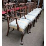 A Set of Six George III Style Dining Chairs, with carved scrolling cresting rails, pierced splats,