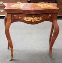 A French Style Marquetry Inlaid Kingwood Fold Over Card Table, of serpentine form on square scroll