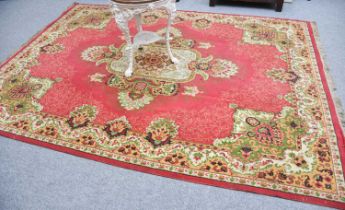 Machine Made Carpet of Oriental Design, the raspberry field centred by ivory medallion enclosed by