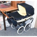 A Silver Cross "Millennium" Pram, numbered 0146, with pale yellow silk-type insert cushion and quilt