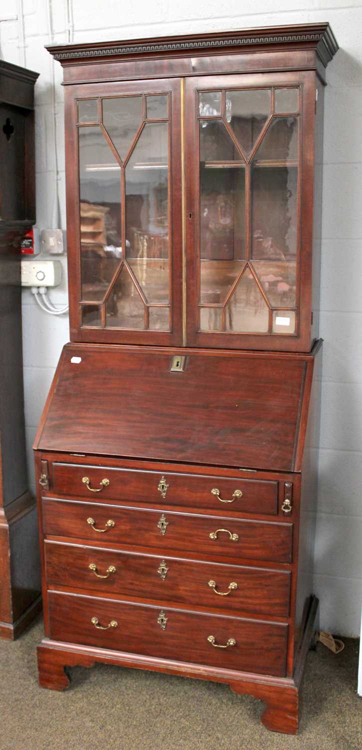 A 19th Century Mahogany Bureau Bookcase of Slender Proportions, with moulded cornice above twin