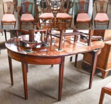 A George III Mahogany D-end Dining Table, and a set of six George III Sheraton-style dining chairs