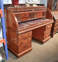 A Victorian Mahogany Roll-Top Pedestal Desk, galleried top over drum form front, opening to reveal