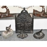 Three Victorian Cast Iron Boot Scrapers and a Cast Iron Fire Back of similar date, 51cm by 75cm