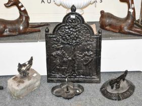 Three Victorian Cast Iron Boot Scrapers and a Cast Iron Fire Back of similar date, 51cm by 75cm