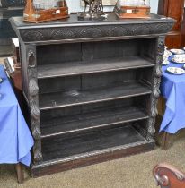 A Carved Oak Open Bookcase, circa 1900, carved with patara to the frieze and with fruit foliage