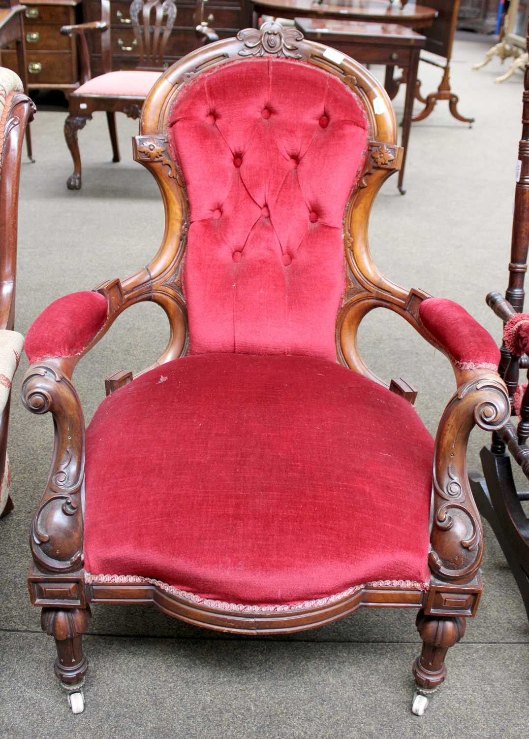 A Victorian Carved Walnut Spoon Back Nursing Chair, with buttoned upholstery and on pot castors