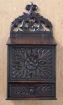 An 19th Century Carved Mahogany Wall Hanging Candle Box, with pierced arch top pedimaent, stylised