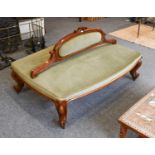 A Victorian Walnut Conversation Settee, upholstered in green velvet, 140cm by 90cm by 80cm