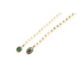 A Cultured Pearl Necklace, the clasp set centrally with an oval nephrite within a Greek key