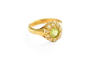 A Peridot and Diamond Cluster Ring, the round cut peridot within a border of old cut diamonds, in