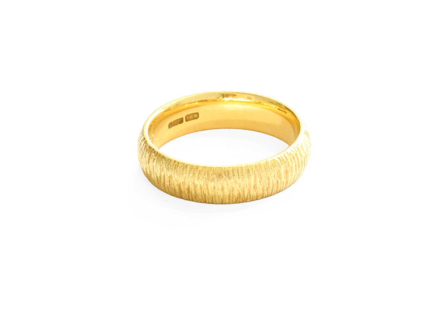 An 18 Carat Gold Textured Band Ring, finger size N1/2 Gross weight 6.4 grams.