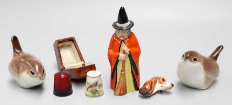 A Royal Worcester Witch Candle Snuffer, a Royal Worcester thimble in case, Royal Doulton fox hound