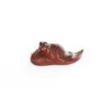 A Japanese Carved Amber Netsuke, late Meiji, formed as a cat upon a giant carp, signed
