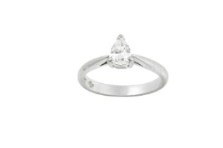 A Platinum Diamond Solitaire Ring, the pear cut diamond in a claw setting, to a tapered shoulder