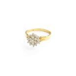 A Diamond Cluster Ring, the central round brilliant cut diamond within a double stepped border of