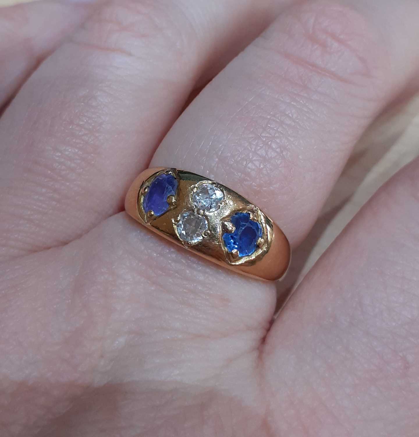 A Sapphire and Diamond Four Stone Ring, the oval cut sapphires spaced by two old cut diamonds, in - Image 4 of 5