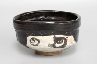 Kato Sakusuke IV (1909-1996), A Japanese Raku Ware Kuro Oribe Style Chawan, signed, Showa period, 7m