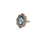 A Blue Topaz, Tourmaline and Diamond Cluster Ring, the oval cut blue topaz within a border of lasque