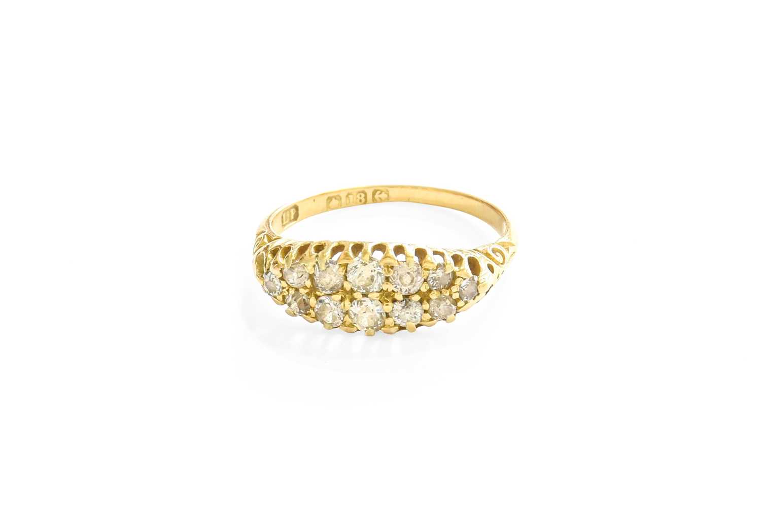 An 18 Carat Gold Diamond Cluster Ring, two rows of old cut diamonds in yellow claw settings, to a