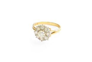 A Diamond Cluster Ring, the central raised round brilliant cut diamond within a border of round