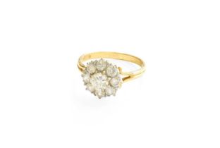 A Diamond Cluster Ring, the centra raised round brilliant cut diamond within a border of round