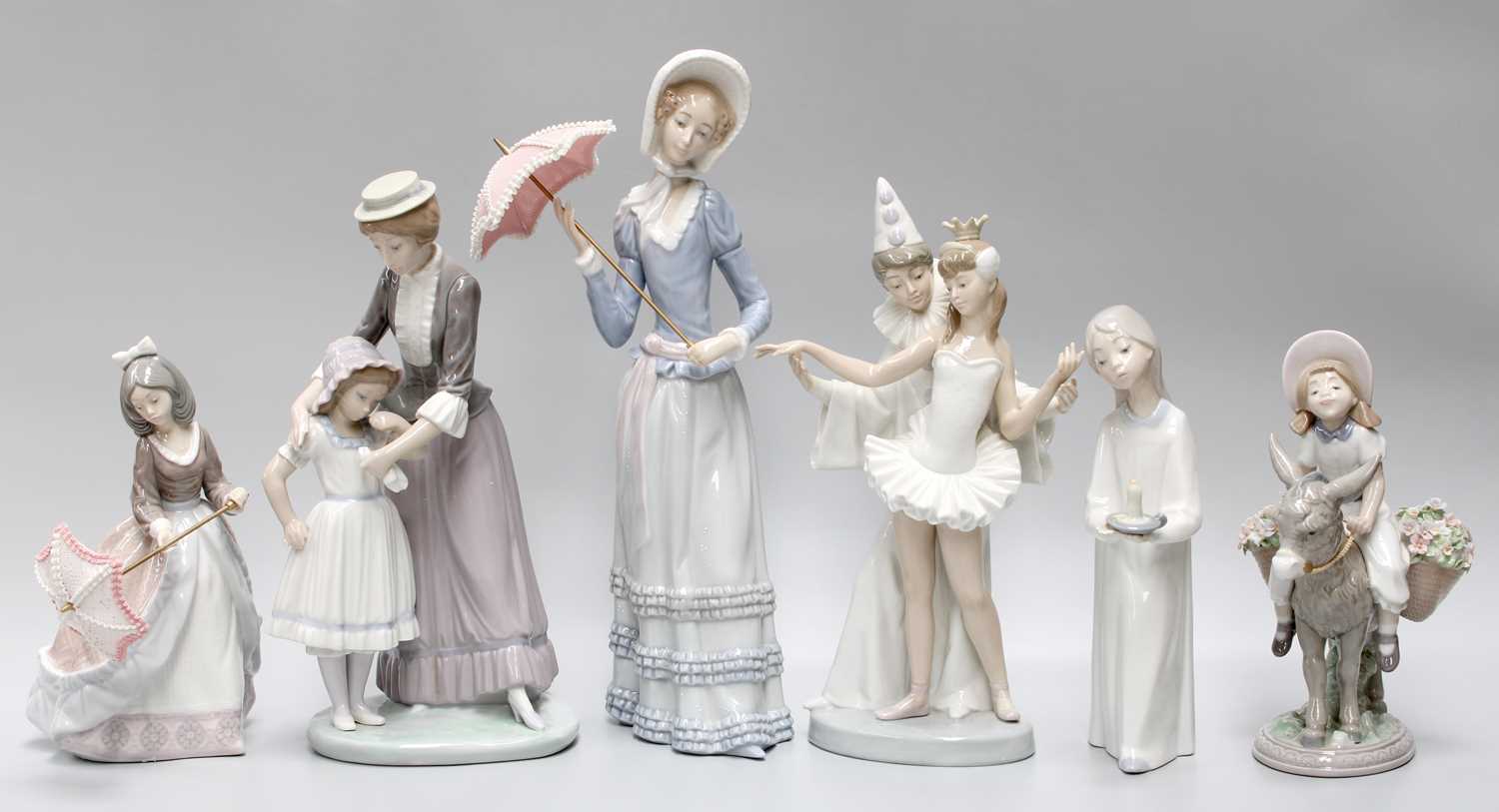 Six Lladro figures, comprising lady with parasol, girl with parasol, girl with chamberstick, Pierrot
