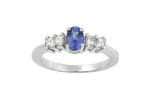 A Tanzanite and Diamond Five Stone Ring, the oval cut tanzanite flanked by pairs of princess cut