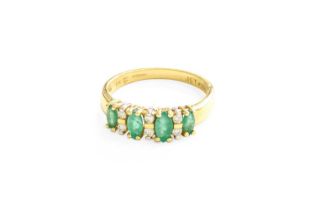 An 18 Carat Gold Emerald and Diamond Ring, five graduated oval cut emeralds in yellow claw settings,
