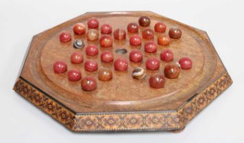 A Victorian Tunbridge Ware Solitaire Board, of octagonal form and on flattened bun feet, with