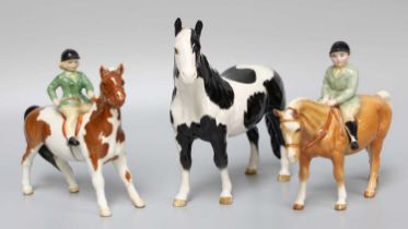 Beswick Girl on Pony, model number 1499, skewbald gloss, and Boy on Pony, model number 1500,