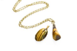 A Tiger's-Eye Pendant on Chain, the irregular shaped tiger's-eye on a trace link chain, pendant