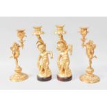 A Pair of 20th Centrury Gilt Metal Figural Candlesticks, in the form of winged putti, 24.5cm high