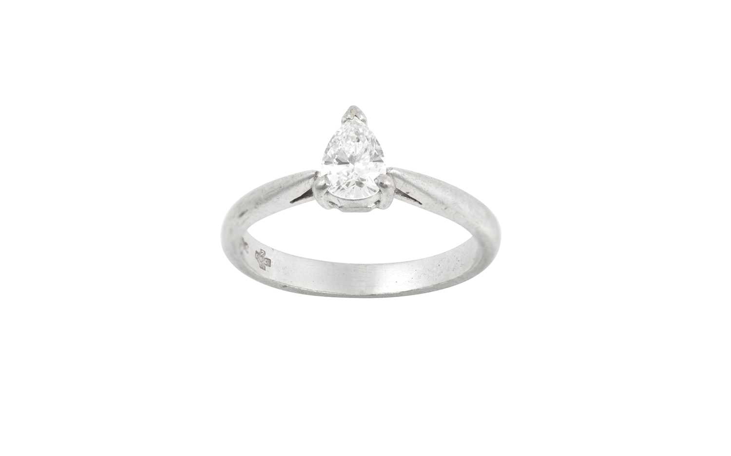 A Platinum Diamond Solitaire Ring, the pear cut diamond in a claw setting, to a tapered shoulder