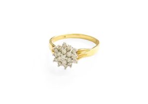 A Diamond Cluster Ring, the central round brilliant cut diamond within a double stepped border of