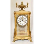 A French Brass Four Glass Striking Mantel Clock, late 19th century, with urn shaped finial and on