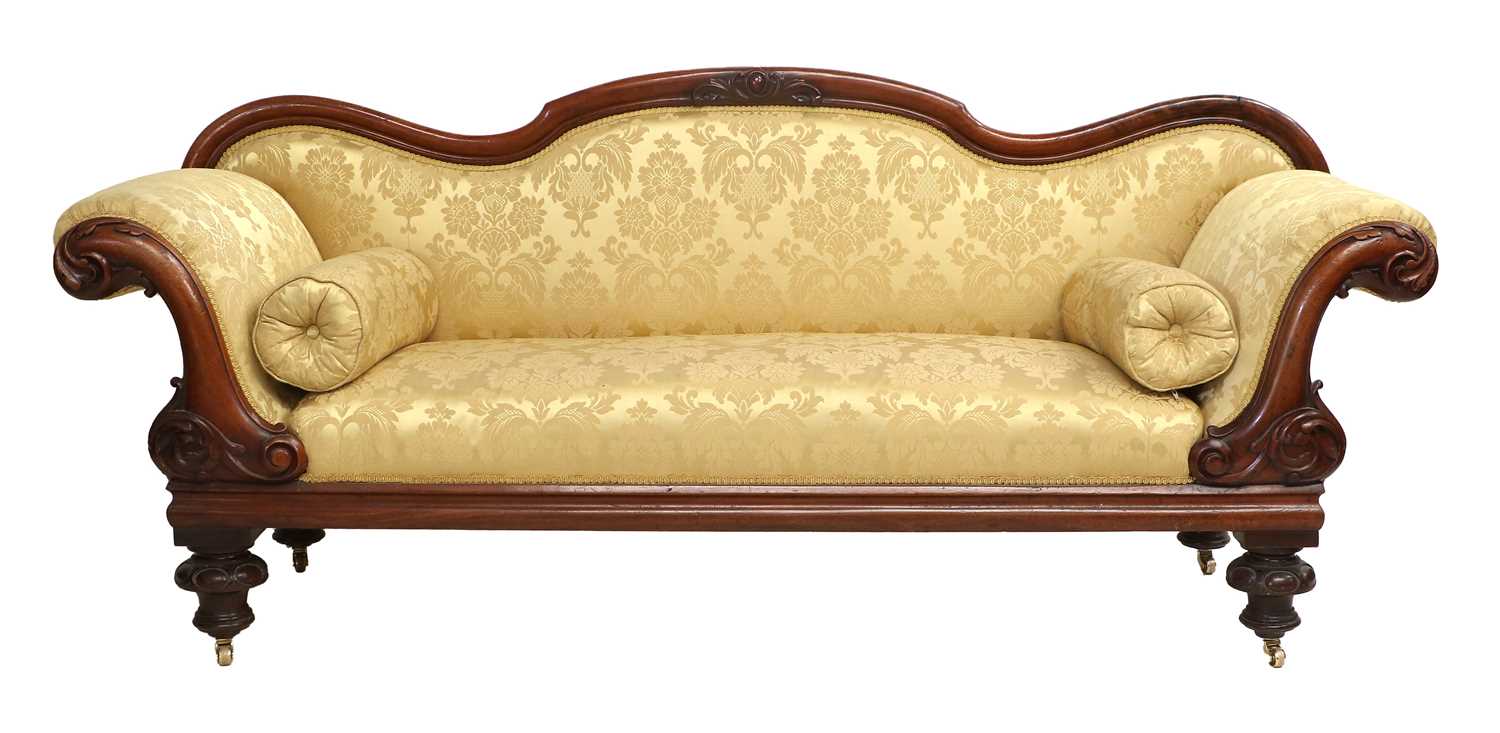A Victorian Carved Mahogany Sofa, circa 1870, recovered in yellow and gold silk damask, with